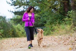 Woman walking her dog - In Home Dog Training